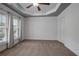 Spacious bedroom with tray ceiling, neutral carpet, and bright natural light at 2268 Limehurst Ne Dr # 120, Atlanta, GA 30319
