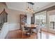 Elegant dining room featuring a round wood table, stylish lighting, and a beautiful view of the outdoors at 2268 Limehurst Ne Dr # 120, Atlanta, GA 30319