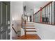 Inviting entryway featuring hardwood floors and elegant staircase with wrought iron spindles at 2268 Limehurst Ne Dr # 120, Atlanta, GA 30319