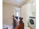 Hallway landing with a washing machine next to a opened door at 2268 Limehurst Ne Dr # 120, Atlanta, GA 30319