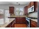 Well-lit kitchen featuring wood cabinetry, granite countertops, and stainless steel appliances at 2268 Limehurst Ne Dr # 120, Atlanta, GA 30319