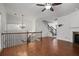 Open living space with fireplace, hardwood floors, and elegant staircase with metal spindles at 2268 Limehurst Ne Dr # 120, Atlanta, GA 30319