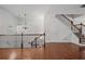 Open-concept living area with hardwood floors, chandelier, and staircase with wrought iron railing at 2268 Limehurst Ne Dr # 120, Atlanta, GA 30319