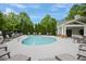 Community pool area with lounge chairs and seating surrounded by trees at 2268 Limehurst Ne Dr # 120, Atlanta, GA 30319
