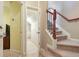 Carpeted stairs with a view of a hallway and doorway with white trim and neutral colored walls at 2268 Limehurst Ne Dr # 120, Atlanta, GA 30319