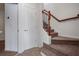 Stairway with carpet, a wooden railing, white walls and trim, and a white entry door at 2268 Limehurst Ne Dr # 120, Atlanta, GA 30319
