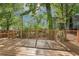 Large wooden deck featuring modern railing and shaded by mature trees at 39 Wyman Se St, Atlanta, GA 30317