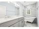 Elegant bathroom with double vanity, clawfoot tub and tiled walls at 39 Wyman Se St, Atlanta, GA 30317
