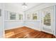 Bright bedroom features wood floors, natural light from multiple windows, and access to the outdoors at 39 Wyman Se St, Atlanta, GA 30317