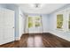 Bedroom with hardwood flooring, a ceiling fan, closet, a window with curtains providing natural light at 39 Wyman Se St, Atlanta, GA 30317