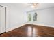 Bedroom featuring hardwood flooring, a ceiling fan, closet, and natural light through a window at 39 Wyman Se St, Atlanta, GA 30317