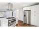 The kitchen features stainless steel appliances, shaker cabinets, a center island and hardwood floors at 39 Wyman Se St, Atlanta, GA 30317