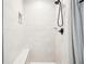 Bright shower with tiled walls, rainfall shower head, and built-in bench at 39 Wyman Se St, Atlanta, GA 30317
