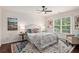 Bright, well-lit bedroom with decorations, a comfortable bed and a cozy reading corner at 448 Cape Ivey Dr, Dacula, GA 30019