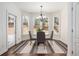 Bright breakfast nook with a view of the backyard, featuring a charming chandelier at 448 Cape Ivey Dr, Dacula, GA 30019