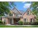Charming two-story brick home with a welcoming front porch and well-manicured landscaping at 448 Cape Ivey Dr, Dacula, GA 30019