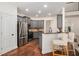 A kitchen with stainless steel appliances, gray cabinets, and a breakfast bar at 448 Cape Ivey Dr, Dacula, GA 30019