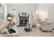 Cozy living room with fireplace, neutral tones, and ample natural light at 448 Cape Ivey Dr, Dacula, GA 30019