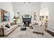 Bright living room with a fireplace, large windows, high ceilings, and a stylish rug at 448 Cape Ivey Dr, Dacula, GA 30019