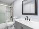 Bathroom featuring a tub and shower combo with tile surround, and gray vanity with black hardware at 2013 Ridge Rd, Dallas, GA 30157