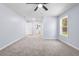 Large bedroom with neutral carpet, a ceiling fan, and natural light from the large window at 2013 Ridge Rd, Dallas, GA 30157