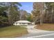 Charming single-story home featuring a large front yard, carport, and bright yellow front door at 2013 Ridge Rd, Dallas, GA 30157