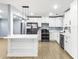 Modern kitchen featuring white cabinets, stainless appliances, a kitchen island and hardwood floors at 2013 Ridge Rd, Dallas, GA 30157