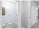 Bright laundry room with white bi-fold doors and light-colored wood-look flooring at 2013 Ridge Rd, Dallas, GA 30157