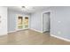 Open-concept living room with French doors leading to the backyard and modern, light-colored hardwood floors at 2013 Ridge Rd, Dallas, GA 30157