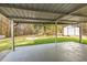 Covered patio area with view of the backyard, mature trees, storage shed, and fire pit at 2013 Ridge Rd, Dallas, GA 30157