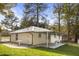 Rear view of home featuring covered patio, metal roof, and landscaped yard with mature trees at 2013 Ridge Rd, Dallas, GA 30157