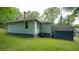A cozy home featuring light blue siding, green lawn and a small storage building at 2881 Parrott Nw Ave, Atlanta, GA 30318