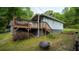 Inviting backyard featuring a spacious wooden deck with steps, firewood, and a cozy fire pit at 2881 Parrott Nw Ave, Atlanta, GA 30318