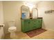 Stylish bathroom with double vanity, updated lighting, and a traditional toilet at 2881 Parrott Nw Ave, Atlanta, GA 30318