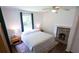Comfortable bedroom featuring neutral decor, a ceiling fan, and a decorative fireplace at 2881 Parrott Nw Ave, Atlanta, GA 30318