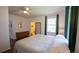 Well-lit bedroom with hardwood floors, ceiling fan, large window, and a dresser at 2881 Parrott Nw Ave, Atlanta, GA 30318
