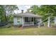 Charming cottage-style home with a welcoming front porch and beautifully landscaped front yard at 2881 Parrott Nw Ave, Atlanta, GA 30318