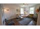 Well-lit living room featuring hardwood floors, a cozy fireplace, and comfortable furniture at 2881 Parrott Nw Ave, Atlanta, GA 30318