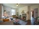 Cozy living room featuring hardwood floors, a decorative fireplace, and ample natural light at 2881 Parrott Nw Ave, Atlanta, GA 30318