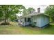 Quaint home featuring a lovely front porch, verdant lawn, and landscaped yard on a sunny day at 2881 Parrott Nw Ave, Atlanta, GA 30318