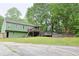 Large green home with a wooden deck, wooden stairs, and an above ground pool in the backyard at 3785 Willow Ridge Rd, Douglasville, GA 30135