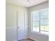 Bright bedroom with a large window, carpet floor, closet, and neutral walls ready for a fresh, new design at 3785 Willow Ridge Rd, Douglasville, GA 30135