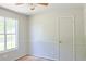 This neutral bedroom features a large window, closet, carpet flooring, and lots of natural light at 3785 Willow Ridge Rd, Douglasville, GA 30135