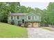 Charming two-story home with an attached two-car garage nestled amidst lush greenery at 3785 Willow Ridge Rd, Douglasville, GA 30135