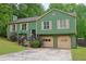 Two-story home featuring an attached two-car garage and a charming wood-accented front porch at 3785 Willow Ridge Rd, Douglasville, GA 30135