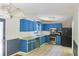 Functional kitchen with blue cabinets, stainless steel appliances, and tiled backsplash at 3785 Willow Ridge Rd, Douglasville, GA 30135