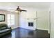 Bright living room with fireplace, ceiling fan, and hardwood floors, creating a cozy atmosphere at 3785 Willow Ridge Rd, Douglasville, GA 30135
