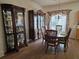 Formal dining room featuring hardwood floors, elegant furnishings, and a large window for natural light at 3828 Dandridge Way, Duluth, GA 30096