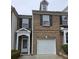Charming brick townhome featuring a one-car garage and traditional black shutters, perfect for easy living at 3828 Dandridge Way, Duluth, GA 30096
