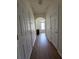 Well-lit hallway featuring hardwood floors and white trim, creating a clean and welcoming transition space at 3828 Dandridge Way, Duluth, GA 30096